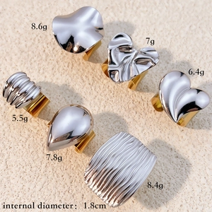 Two-tone 18k gold and silver stainless steel rings in various abstract shapes and textures
