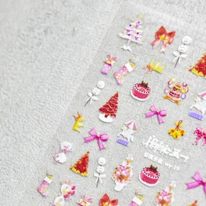 Detailed macro view of 5D embossed Christmas nail stickers with pink carousel and bow designs