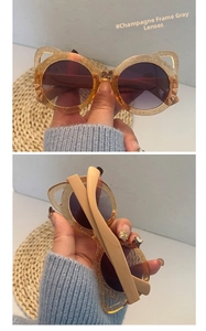 Detailed view of champagne glitter cat-ear children's sunglasses with grey lenses