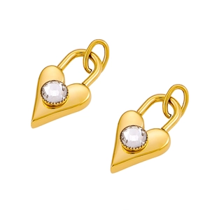 Detailed close-up of golden heart earrings with sparkling round cubic zirconia stones