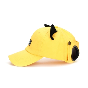 Yellow baseball cap with 3D cat ears and pilot goggles decoration on plain background