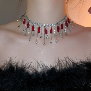 Close-up of royal style choker with crystal tassels and red waterdrop pendant for women
