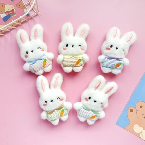 Set of five plush cartoon bunny accessories with carrot embroidery in pastel colors