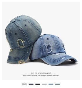 Detail of distressed washed denim baseball caps with vintage frayed holes and worn-out texture