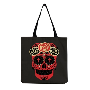 Close-up of black canvas tote bag with vibrant Mexican Dia de los Muertos skull print