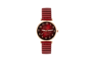 Detail of rose gold quartz watch featuring a red leaf dial and elastic metal band
