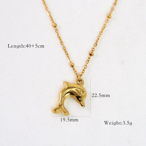 Detail of 14k gold dolphin pendant necklace with exact size and length measurements