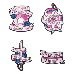 Set of four colorful enamel lapel pins with inspirational quotes on a white background