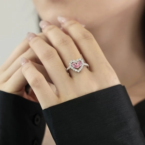 Detailed view of pink heart-shaped zircons on an S925 silver ring worn by a model