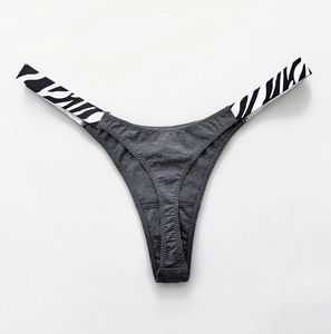 Detailed view of dark grey cotton thong with zebra print side straps and high-cut waist