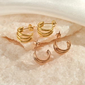 Three-layer hollow C-shaped stud earrings in gold and rose gold finishes on white stones