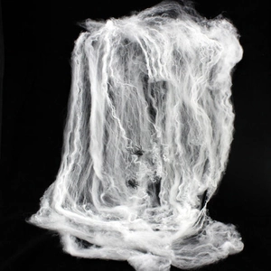 Detailed view of white artificial cobweb with two black spiders for Halloween decor