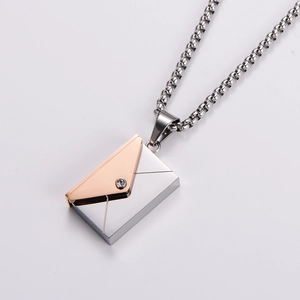 Close-up of envelope pendant with silver and rose gold tones and small white crystal detail