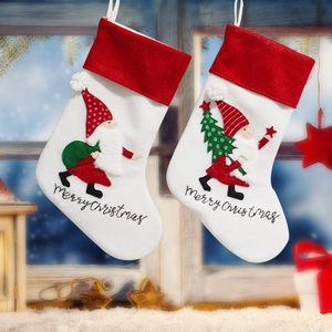 Festive Christmas socks with Santa Claus applique hanging in a snowy window scene