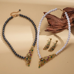 Vintage style faux pearl necklace set with crystal flower charms in gold finish