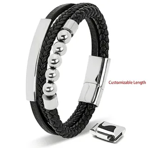 Close-up of black braided leather men's bracelet with silver stainless steel tube and magnetic clasp
