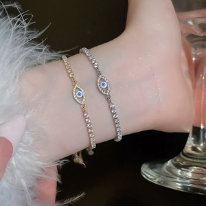 Close-up of sparkling cubic zirconia evil eye bracelet with gold and silver finishes