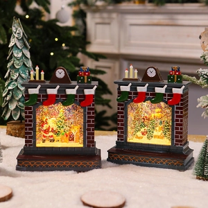 Detail of Christmas fireplace snow globe with Santa and glowing LED holiday scenes