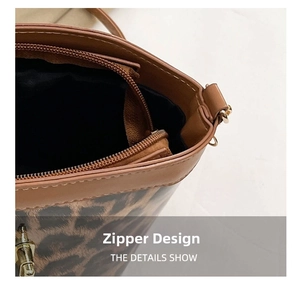 Close-up detail of leopard print bucket bag with metal zipper and gold hardware
