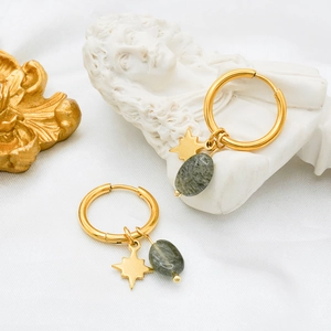Detailed shot of gold plated earrings featuring star charms and green amazonite beads
