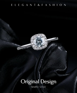 Macro shot of cushion cut grey moissanite ring with halo setting on black leather background