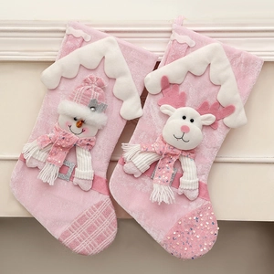 Pink sequin Christmas stockings featuring plush snowman and reindeer on fireplace mantel