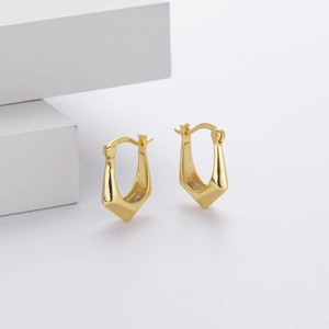 Macro shot showing the S925 hallmark on polished gold-plated sterling silver hoop earrings