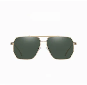 Detail of pilot sunglasses with gold metal frame and green lenses featuring a double bridge