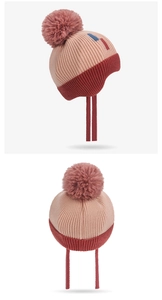 Detail of color-block knit baby winter hat with pompom, earflaps and back stripes