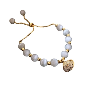 Elegant grey cat's eye bead bracelet with gold shell pendant and pavé stones
