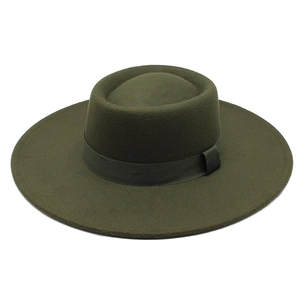 Detail view of the olive green wool fedora hat with matching ribbon and oval crown top