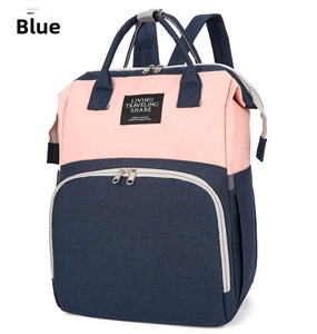 Detail of waterproof Oxford fabric backpack showing navy blue and pink contrast with label