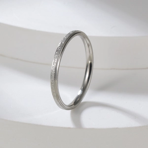 Detailed view of 2mm silver stainless steel ring with half frosted and half polished texture