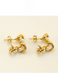 Detail of 18K vacuum plated gold earrings with twisted metal and white pearls
