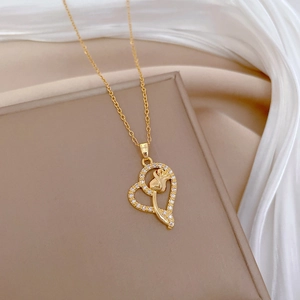 Luxurious gold heart pendant necklace with micro-diamonds on white silk background