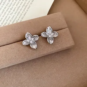 Elegant silver flower stud earrings with marquise-cut zircon on brown velvet stand