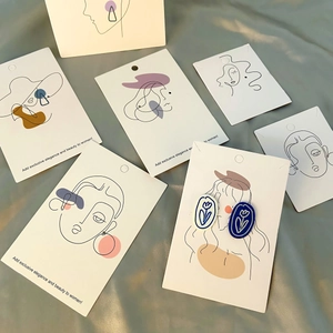 Artistic tulip flower earrings set displayed on elegant minimalist line art cards