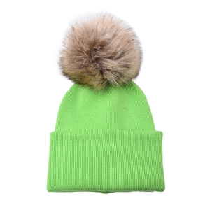 Detailed close-up of neon green ribbed knit beanie with soft faux fur pom-pom detail