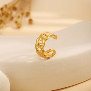 Gold-plated Cuban link ear cuff on a wave display stand with a minimalist vintage look