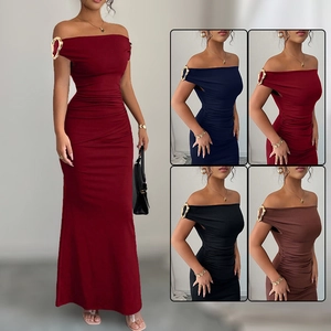 Detail of elegant off-shoulder evening dress featuring unique gold metal ring ornaments on cuffs