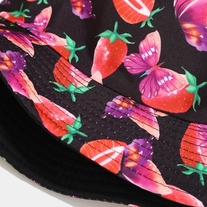 Detail of multi-row stitching on brim of black bucket hat with strawberry and butterfly print