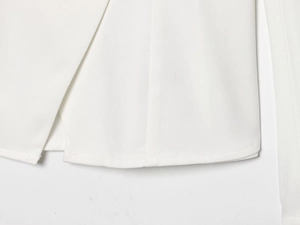 Detailed macro view of white woven fabric texture and stitching on the slim fit blazer
