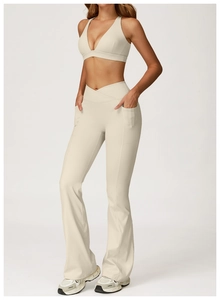 Detail of cream yoga set showing cross waist flared pants and V-neck sports bra
