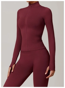 Detail of burgundy yoga jacket showing functional thumbhole cuffs and slim fit silhouette