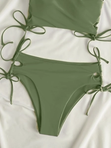 Detail view of olive green bikini with adjustable side ties and shiny high-stretch fabric