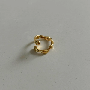Macro shot of 18k gold plated stainless steel ring with irregular geometric wavy design