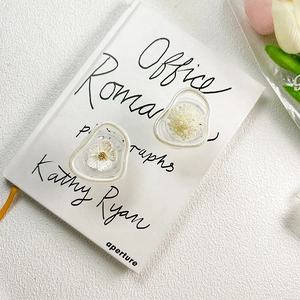 Detailed view of floral and pearl-encrusted phone socket grip on a decorative book