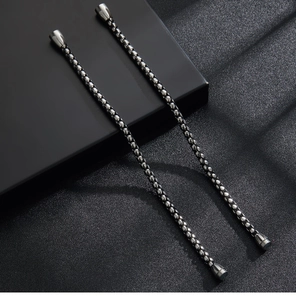 Detail view of double black layered cords with polished stainless steel magnetic clasps