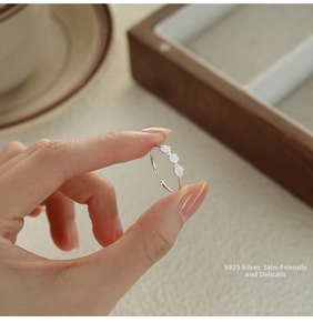 Macro shot of S925 sterling silver ring featuring three delicate flowers with micro zircons