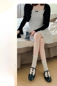 Bamboo fiber polka dot socks with lace trim shown on feet in a cozy home setting